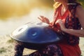 beautiful woman playing with hangdrum in nature. Royalty Free Stock Photo