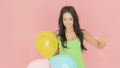 Beautiful woman playing with party balloons