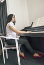 Beautiful woman playing piano Royalty Free Stock Photo