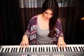 Beautiful woman playing on piano Royalty Free Stock Photo