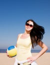 Beautiful woman playing volleyball at the beach