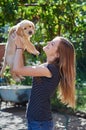 Beautiful woman playing with a white Labrador puppy Royalty Free Stock Photo