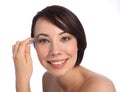 Beautiful woman plucking eyebrow with tweezers Royalty Free Stock Photo