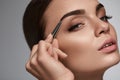 Beautiful Woman Plucking Eyebrows. Beauty Brows Correction Royalty Free Stock Photo