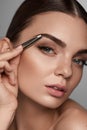 Beautiful Woman Plucking Eyebrows. Beauty Brows Correction