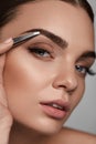 Beautiful Woman Plucking Eyebrows. Beauty Brows Correction Royalty Free Stock Photo