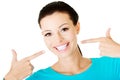 Beautiful woman pointing on her perfect white teeth. Royalty Free Stock Photo