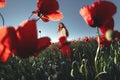 Beautiful woman in a poppy field Royalty Free Stock Photo