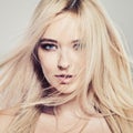 Beautiful woman portrait. Blonde girl face, healthy skin and blowing hair Royalty Free Stock Photo