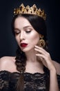Beautiful woman portrait with crown and earrings.