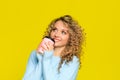 Beautiful woman portrait with curly hair on yellow background posing with coffee - Image