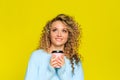 Beautiful woman portrait with curly hair on yellow background posing with coffee - Image