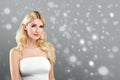 Beautiful woman portrait in dress over gray snow winter background