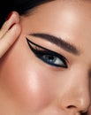 Beautiful woman portrait with fresh daily make-up black hair and healthy skin. perfect eyeliner arrows. Eyebrows Care. Closeup Of Royalty Free Stock Photo