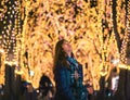 Beautiful Woman in winter clothing at night in The Jozenji christmas light up festival in Sendai, Japan Royalty Free Stock Photo