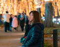 Beautiful Woman in winter clothing at night in The Jozenji christmas light up festival in Sendai, Japan Royalty Free Stock Photo