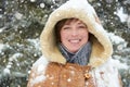 Beautiful woman portrait on winter outdoor, snowy fir trees in forest, long red hair, wearing a sheepskin coat Royalty Free Stock Photo