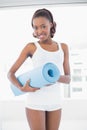 Beautiful woman posing with exercise mat