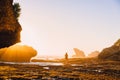 Beautiful woman posing near ocean with rocks and sunset. Woman in bikini at ocean Royalty Free Stock Photo