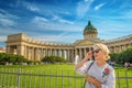 Beautiful woman posing over Kazan Cathedral in St. Petersburg