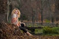 Beautiful woman posing in park during autumn season. Blonde girl wearing green blouse and big shawl posing outdoor. Long fair hair Royalty Free Stock Photo