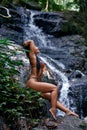 Beautiful woman posing at small tropical waterfall Royalty Free Stock Photo