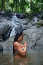 Beautiful woman posing at small tropical waterfall Royalty Free Stock Photo