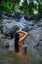 Beautiful woman posing at small tropical waterfall Royalty Free Stock Photo