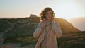 Beautiful woman posing sunset ocean view. Relaxed tourist admiring seaside Royalty Free Stock Photo