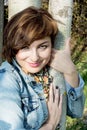 Beautiful woman posing with tree trunk Royalty Free Stock Photo