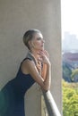 Beautiful woman posing on urban balcony