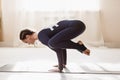 Beautiful woman practicing yoga doing balance handstand, crane pose, bakasana