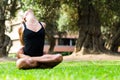 Beautiful woman practicing yoga in the park.The Locked Lotus Pose Baddha Padmasana.