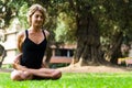 Beautiful woman practicing yoga in the park.The Locked Lotus Pose Baddha Padmasana.