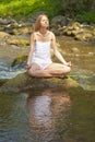 Beautiful Woman Practive Yoga On River In Nature