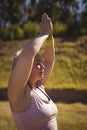 Beautiful woman praising yoga during obstacle course