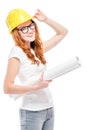 beautiful woman with projects in a yellow hard hat against Royalty Free Stock Photo