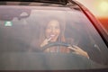 Beautiful woman putting on lipstick in car Royalty Free Stock Photo