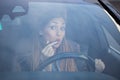 Beautiful woman putting on lipstick in car Royalty Free Stock Photo