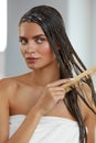 Beautiful Woman Putting Mask On Long Wet Hair. Hairbrushing Royalty Free Stock Photo