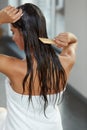 Beautiful Woman Putting Mask On Long Wet Hair. Hairbrushing Royalty Free Stock Photo