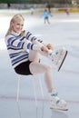 Beautiful woman putting skates on Royalty Free Stock Photo