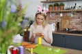 Beautiful woman in a rabbit`s ears sews Easter decorations