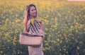 Beautiful woman in rapeseed field