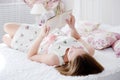 Beautiful woman reading a book in bed Royalty Free Stock Photo