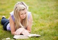 Beautiful woman reading a book in a park Royalty Free Stock Photo