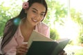 Beautiful young woman reading book in park on sunny day Royalty Free Stock Photo