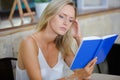 beautiful woman reading book in restaurant Royalty Free Stock Photo
