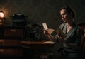 Beautiful woman reading letter in retro interior