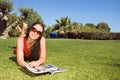 Beautiful woman reading magazine in the park Royalty Free Stock Photo